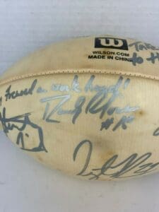 Autographed football with various signatures and messages.