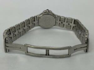 Silver watch bracelet with open clasp.