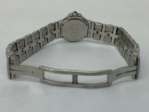 Silver watch with engraved metal bracelet.