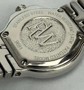 Back of stainless steel wristwatch with engraving.