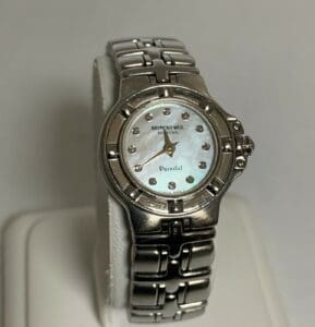 Silver wristwatch with pearl face display.