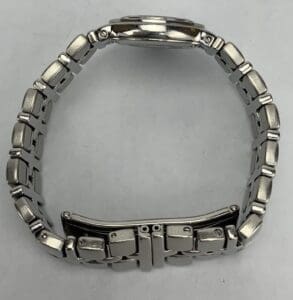 Silver metal watch band on white background.