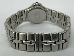 Silver watch with intricate metal bracelet.