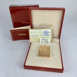 Gold lighter in open red display box.