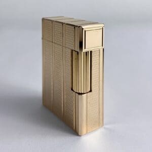 Gold luxury lighter with textured design.