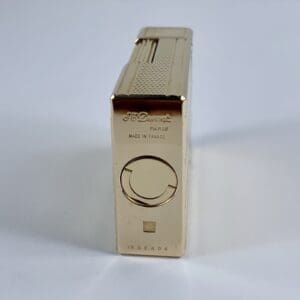 Gold S.T. Dupont lighter, standing upright.