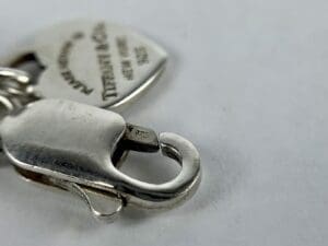 Silver clasp with engraved pendant detail.