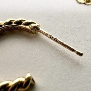Close-up of a twisted gold earring.