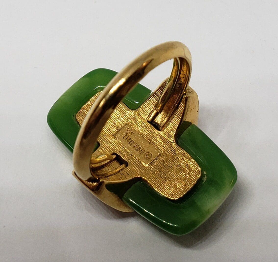 Gold and green vintage ring on display.
