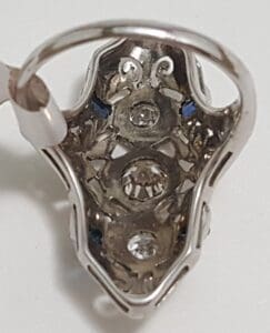 Intricate silver earring with gemstone details.