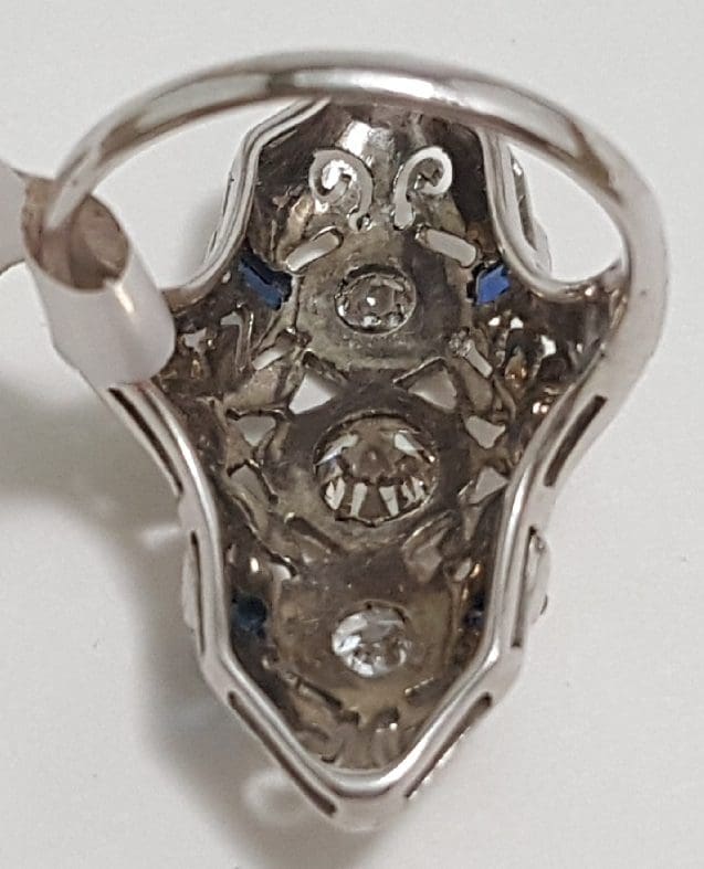 Intricate silver earring with gemstone details.