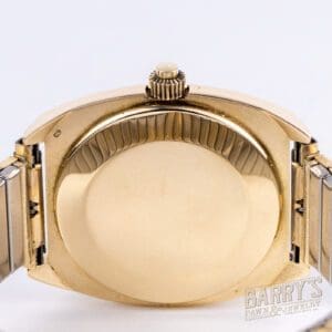 Gold wristwatch back with metal strap.