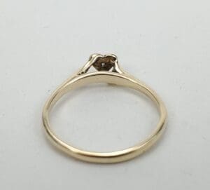 Gold ring with heart-shaped setting.