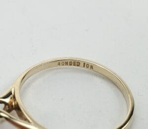 Gold ring engraved with "Bonded 10K.