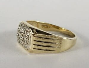 Gold ring with diamond cluster design.