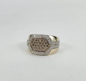 Gold ring with hexagonal diamond setting.
