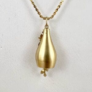 Gold pendant necklace with floral design.