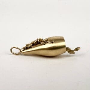 Gold pendant with floral design motif.
