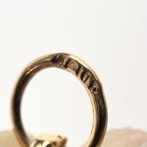 Close-up of a gold ring with marks.
