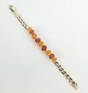 Gold bracelet with orange gemstone beads.
