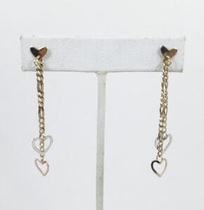 Gold chain earrings with heart charms.