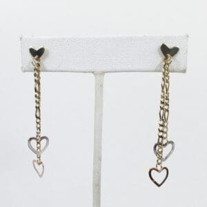 Gold chain earrings with heart pendants.