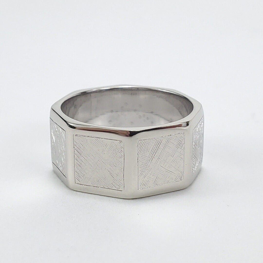Silver geometric band with textured design.