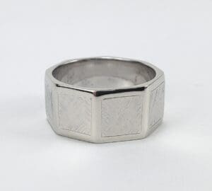 Silver octagonal ring with textured surface.