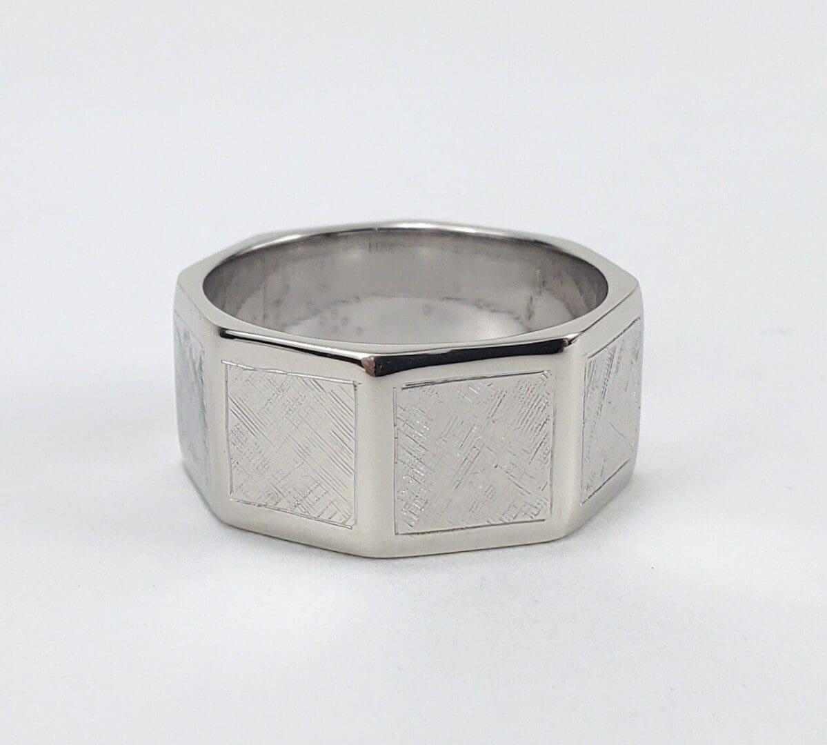 Silver octagonal ring with textured surface.