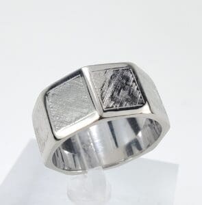 Silver ring with textured geometric design.