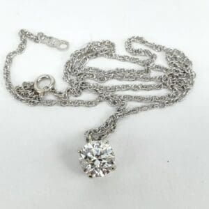 Silver necklace with a round diamond pendant.