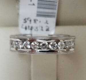 Diamond ring with price tag displayed.