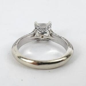 Silver engagement ring with central diamond.