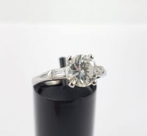 Diamond ring on black stand.