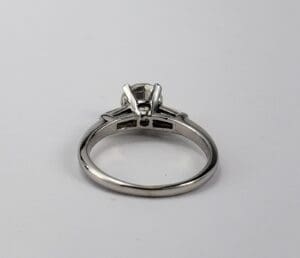 Silver engagement ring with solitaire diamond setting.