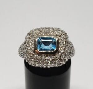 Silver ring with blue gemstone centerpiece.