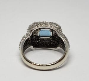 Silver ring with blue gemstone and diamonds.