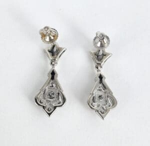 Silver drop earrings with intricate design.