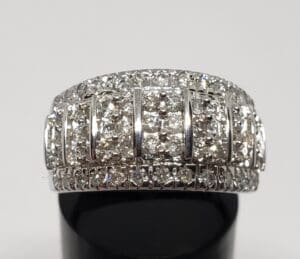 Diamond-encrusted silver ring with layered design.