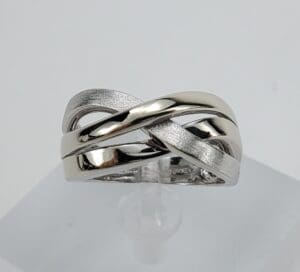 Silver intertwined band ring on display.