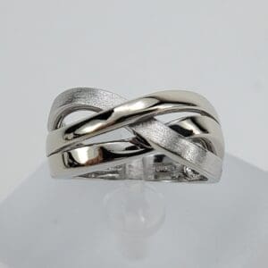 Silver intertwined band ring on display.
