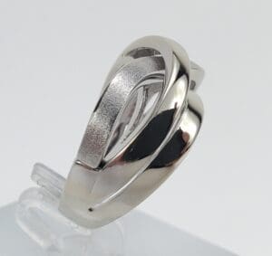Silver ring with modern, intertwined design.