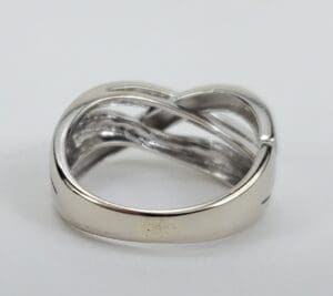 Silver twisted band ring on display.