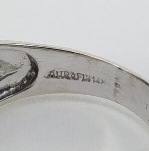 Silver ring with engraved inscription inside band.