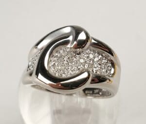 Silver ring with embedded small diamonds.