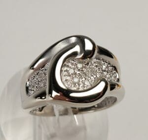 Silver ring with intricate diamond design.