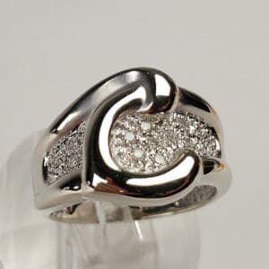 Silver ring with intricate diamond design.