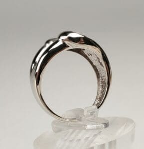 Silver ring on a clear display stand.