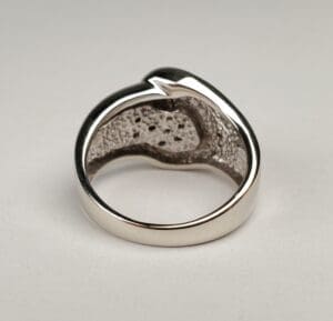 Silver ring with textured inner surface.