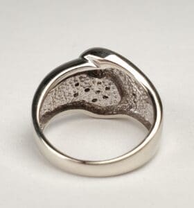 Silver ring with textured inner surface.